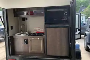 Camo Sunset Park RV Sunray Micro Trailer with toy hauler on front